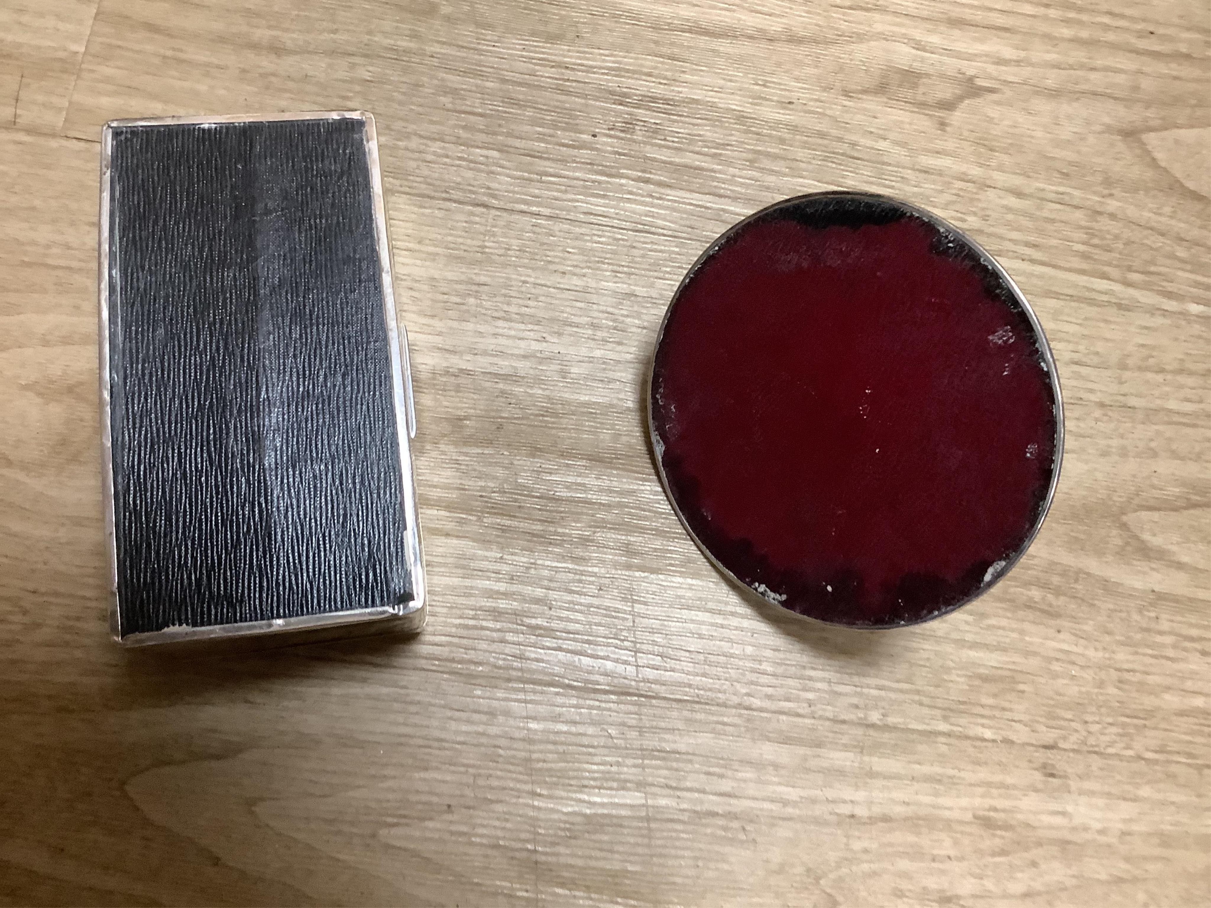 A silver mounted capstan inkwell, Birmingham, 1914, a silver mounted cigarette box and a cased pair of silver menu holders. Condition - poor to fair